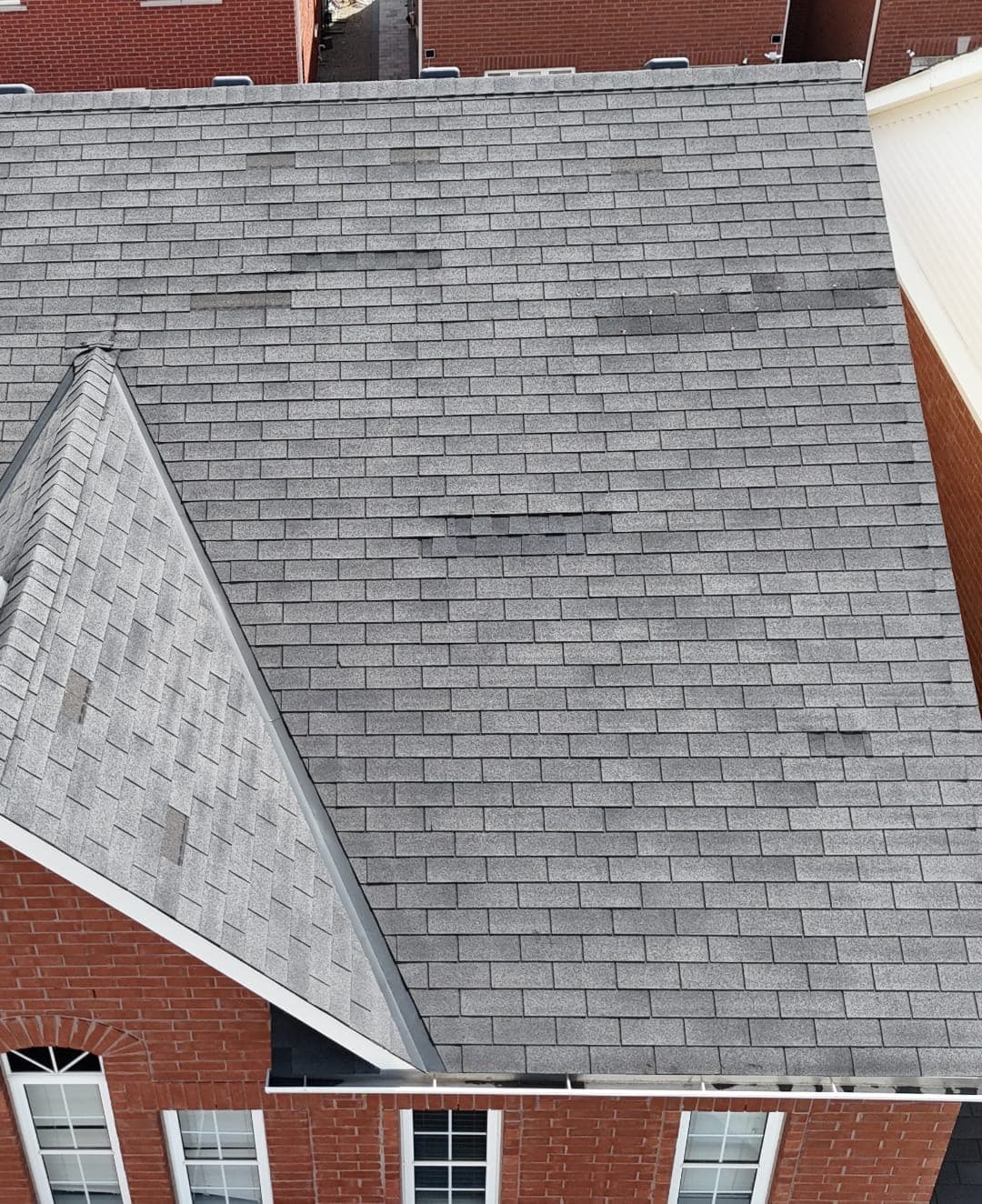 Close-up drone photo of asphalt shingle wear and damage